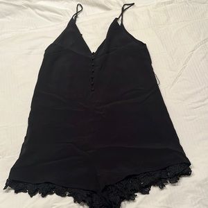 Black lace trimmed shorts spaghetti strap romper. Sexy lace trim at legs/neck